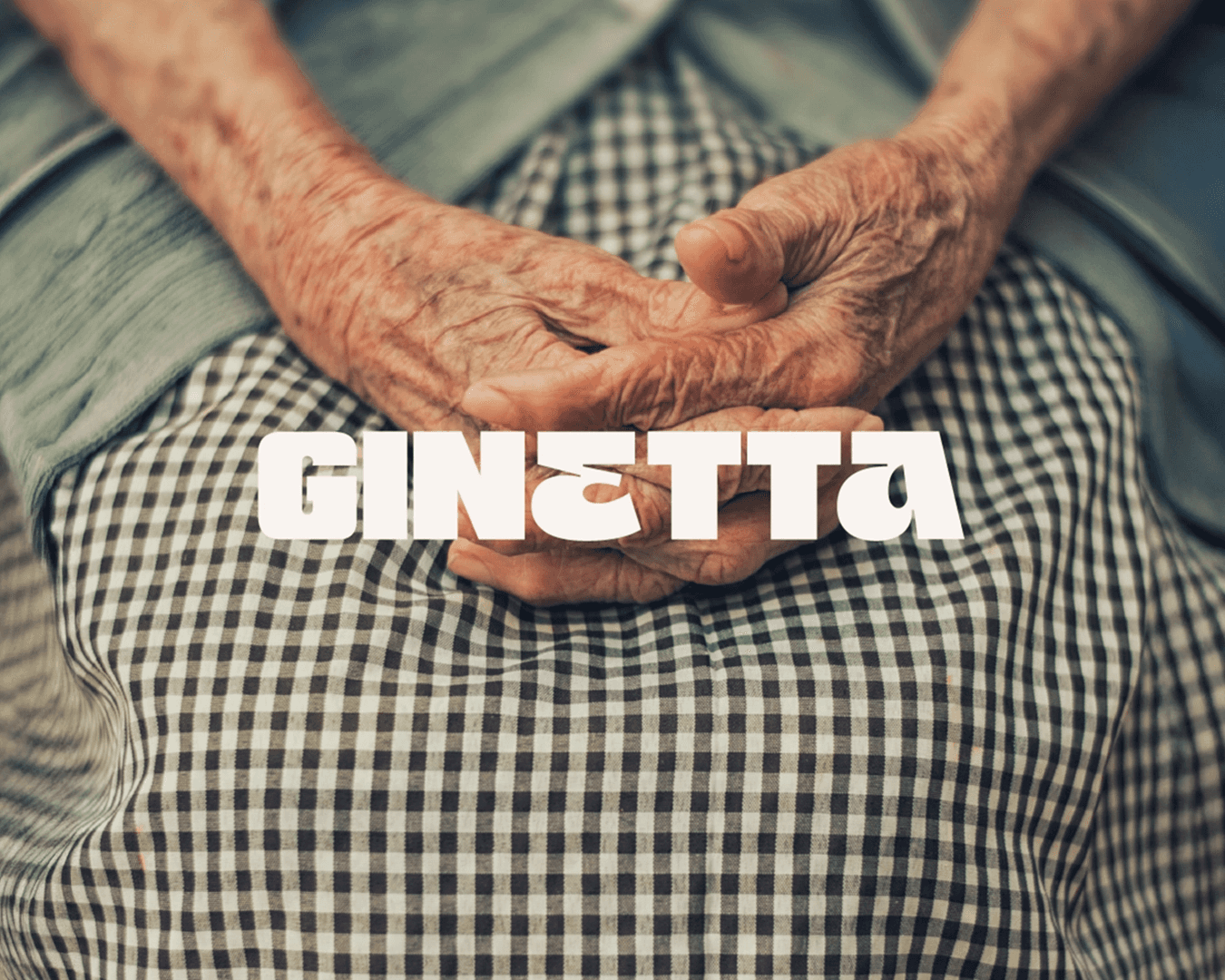 Ginetta Branding - Italian grandmother's hands on gingham skirt, symbol of heritage and authenticity