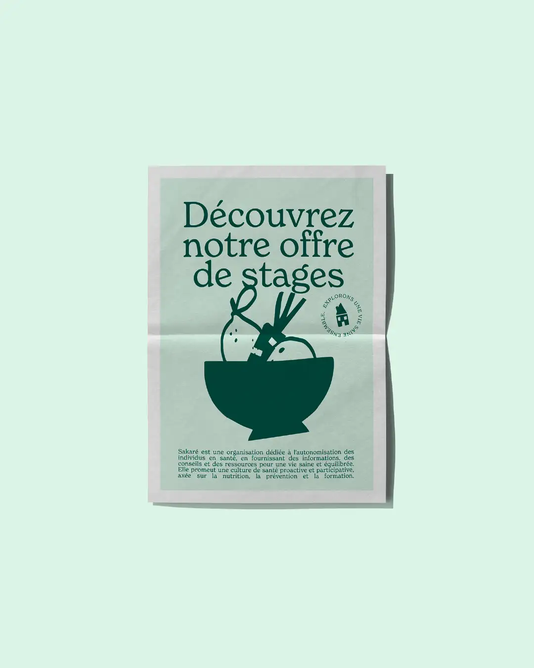 Sakaré composition on light green background: folded newspaper cover with center crease, dark green editorial layout featuring "Discover our internship offer" headline, fruit basket illustration and body text footer